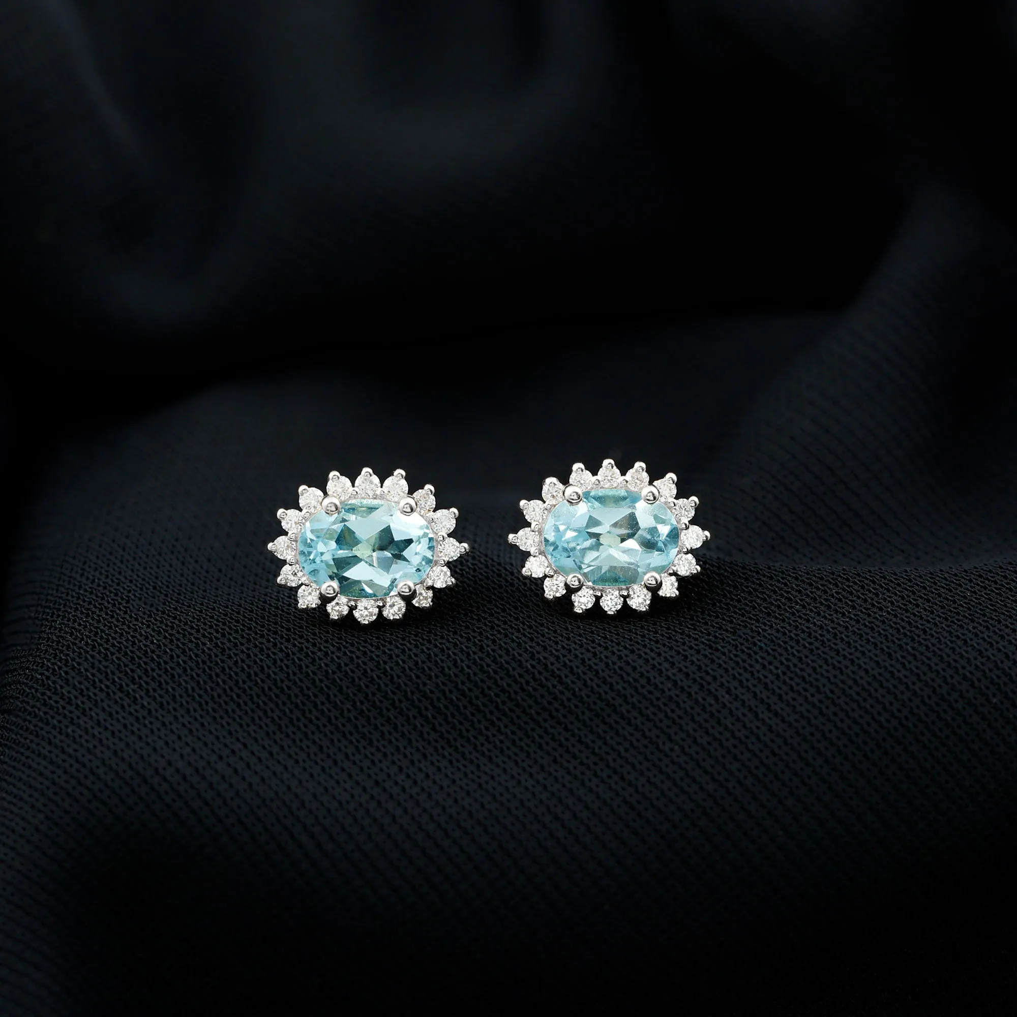 1.75 CT Oval Sky Blue Topaz Classic Stud Earrings with Diamond Halo